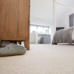 Neatly decorated bedroom with carpeting