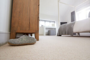 Neatly decorated bedroom with carpeting