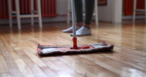 Woman using mop cleaner to maintain hardwood floors